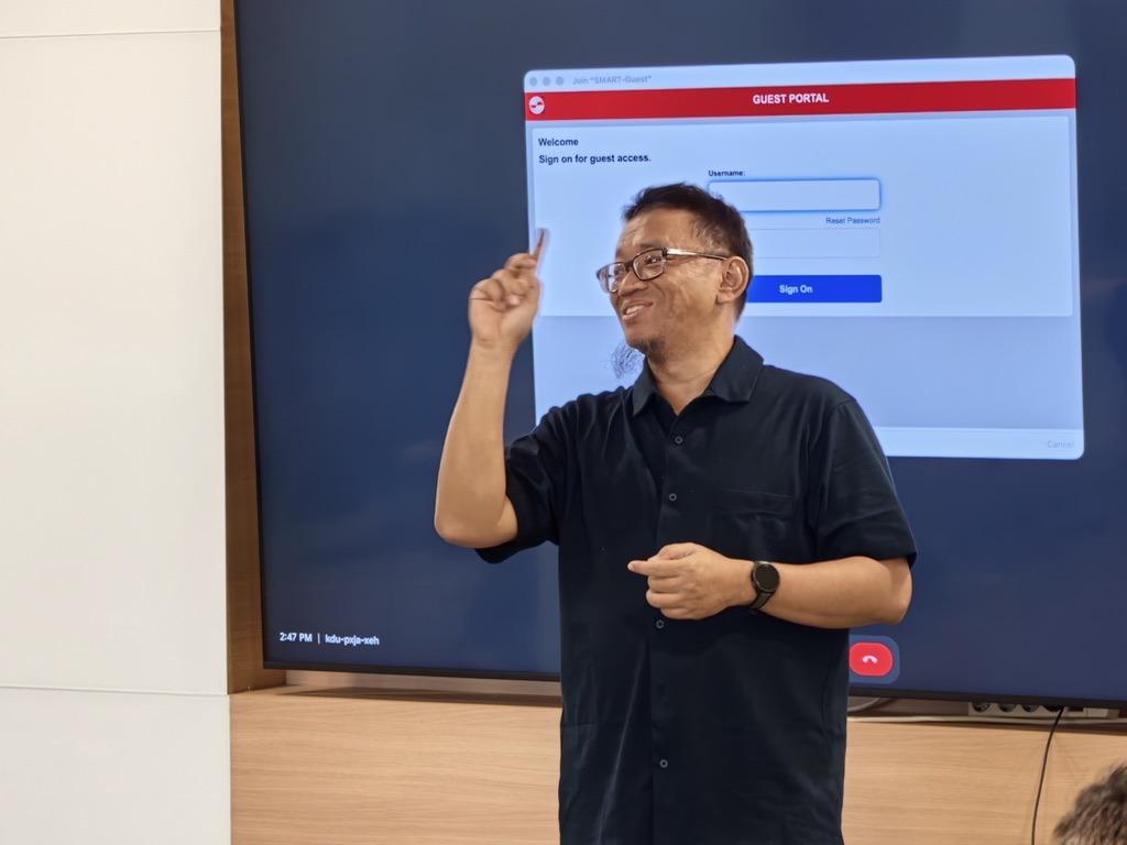 Facilitator leading a Hyperjump AI workshop in front of a screen